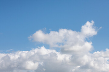 Drifting clouds in a blue sky.