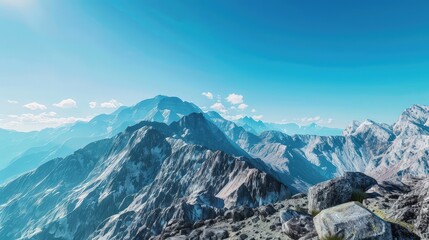 A realistic mockup scene of a rugged mountain range under a clear blue sky, ideal for advertising hiking or camping gear against the backdrop of nature's majesty.