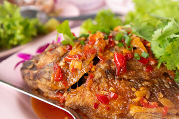 Crispy fried fish topped with spicy sauce