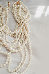 Pearl necklace. Shiny background of jewelry. Royal luxury pearl beads