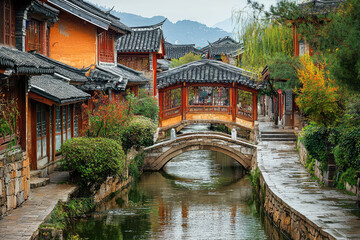 Obraz premium A tranquil moment in Lijiang, China, where a quaint stone bridge arches over a serene canal, leading to a picturesque ancient town.