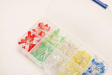 Multicolored LEDs in a plastic box on a white background. LED radio elements.