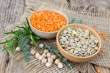 lentils and fresh herbs - wooden background
