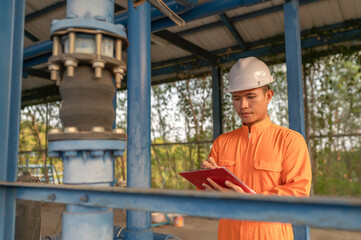 Engineer and technician maintenance checking technical data of system equipment Condenser Water pump and pressure gauge,environmentalist working at water supply