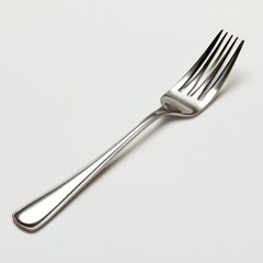 The shiny fork lies poised reflecting subtle light inviting its use for a delicious meal