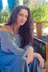 Woman in Gray Outfit Relaxing on a Wooden Deck with Yellow Shoes