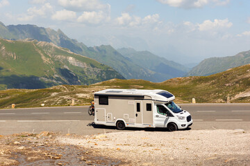 Scenic view big modern white family rv camper van vehicle drive Europe highway road alpine pass...
