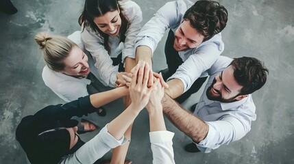 A diverse group of smiling coworkers celebrate a win with a high five.