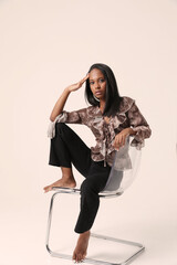 Fototapeta premium Beautiful dark-skinned woman dressed in casual clothing , stock photo. Vertical.