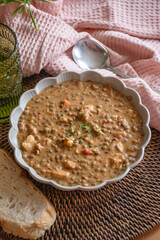 Lentil Dish. A comforting bowl of lentils served on a homely dining table, surrounded by warm, inviting home decor. 