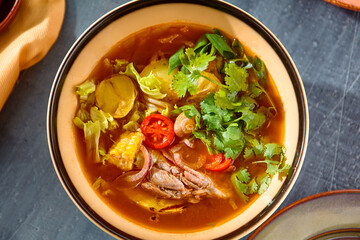 Vibrant Lamb and Vegetable Soup in a Rustic Setting - Warm Tones and Playful Composition