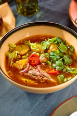 Vibrant Lamb Vegetable Soup in Golden Bowl - Rustic Composition with Fresh Ingredients