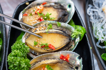 Korean seafood dishes. Grilled abalone shell