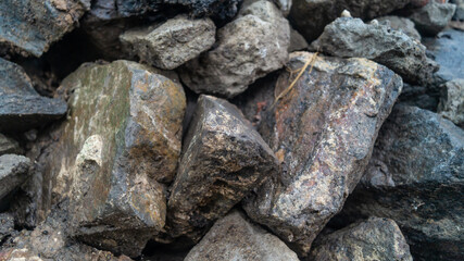 A pile of large stones during the rain. Big wet rocks close-up