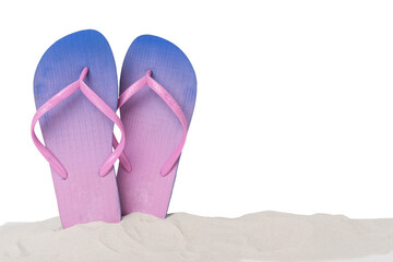 Flip flops on sand against isolated background