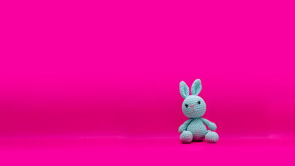 Stuffed vintage bunny with pink background 