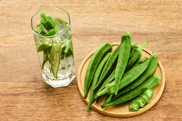 Fresh Okra water on wooden background