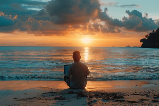 A man sits on the beach with a laptop open, watching the sun set over the ocean,generative ai image