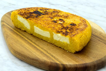 Delicious just grilled sweet yellow corn hand made arepa de chocolo.