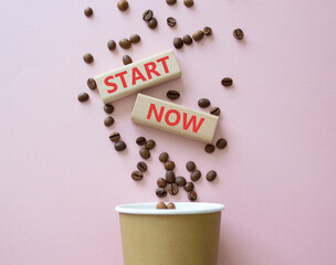 Start here symbol. Wooden blocks with words Start here Beautiful pink background with coffee cup...