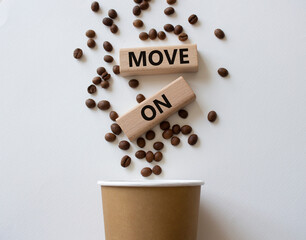 Move on symbol. Concept word Move on on wooden blocks. Beautiful white background with coffee beans and cup. Business and Move on concept. Copy space