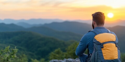 An adventure traveler who hikes appreciates taking a pause to look at the summit of the mountain at dusk.