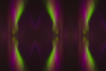 Mesmerizing Aurora Borealis: A Vibrant Display of Purple and Green Lights Dancing Across the Night Sky, Creating a Captivating Symmetrical Pattern Against a Backdrop of Stars, Perfectly Capturing the 