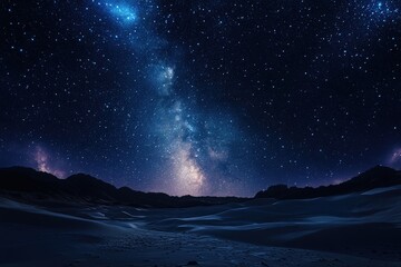 Obraz premium Starry night sky above a desert landscape.