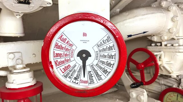 Engine order telegraph or Chadburn, communication device on a German submarine from the bridge to the engine room in bright red with gauge, dial and German text, for engine control