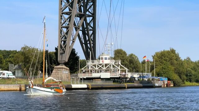 Schwebef&auml;hre Rendsburg suspended ferry crossing from high steel suspension bridge across the kiel canal nord ostsee kanal through germany in summer