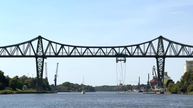 Schwebef&auml;hre Rendsburg suspended ferry crossing from high steel suspension bridge across the kiel canal nord ostsee kanal through germany in summer