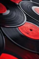 A selection of red and black vinyl records stacked on a shelf