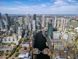 Fototapeta premium Aerial view of the Canary Wharf business district in London. Panoramia of the skyscrapers in London. Canary Wharf is part of London's central business district.