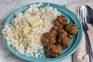 rice top with butter  served with meat balls