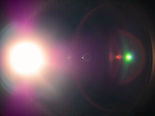 Bright star light flares in dark space background, creating epic array of colorful halos and reflections. Lens flare overlay effect.