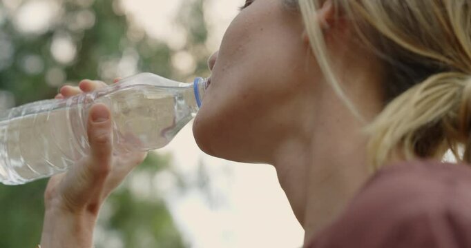 Young woman drinking a bottle of water