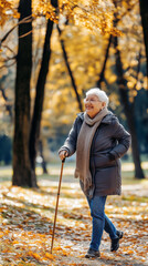Fototapeta premium Elderly Woman Enjoying a Peaceful Walk in a Park During Autumn