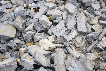 Post renovation debris. Concrete, brick, and gypsum fragments. Dirty dusty texture. Broken materials and construction waste texture. Extensive building work. Cracked bricks. Dusty trash background.