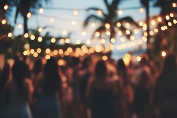 Outdoor evening celebration with string lights and blurred crowd under palm trees