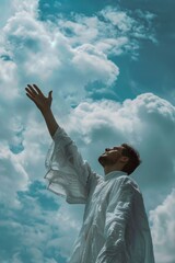 A person in a white robe stretching upwards, possibly praying or seeking guidance