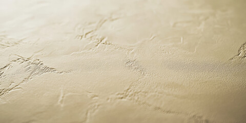 A light almond-colored surface with a smooth, matte texture. The warm, neutral tone and subtle texture add a modern and inviting feel to the background.