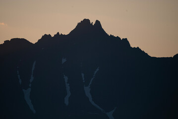 Stunning sunset over mountains and sea on wild natural islands in the northern region of the world,...