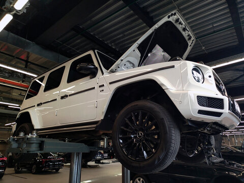 Moscow, Russia &ndash; September 04, 2024: White Mercedes Gelendvagen in a car service on a lift. Repair and maintenance of Mercedes Benz cars.