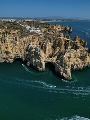 This aerial photo captures the stunning rock formations and turquoise waters at Ponta da Piedade in Lagos, Algarve. 