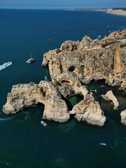 This aerial photo captures the stunning rock formations and turquoise waters at Ponta da Piedade in Lagos, Algarve. 