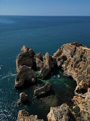 This aerial photo captures the stunning rock formations and turquoise waters at Ponta da Piedade in Lagos, Algarve. 