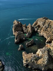 This aerial photo captures the stunning rock formations and turquoise waters at Ponta da Piedade in Lagos, Algarve. 