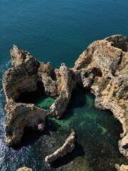 This aerial photo captures the stunning rock formations and turquoise waters at Ponta da Piedade in Lagos, Algarve. 