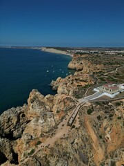 This aerial photo captures the stunning rock formations and turquoise waters at Ponta da Piedade in Lagos, Algarve. 