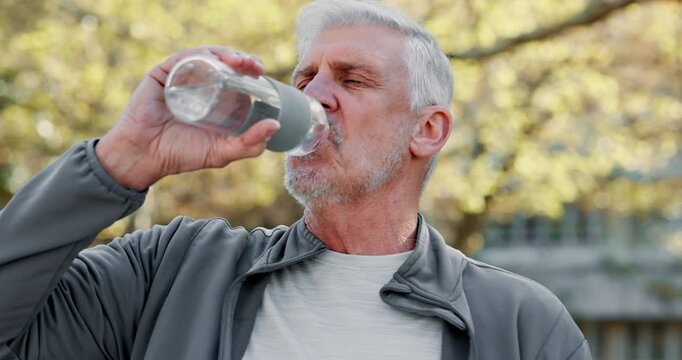 Drinking water, outdoor and hydration of mature man, fitness and break in park, training and sportswear. Runner, workout and person with bottle, exercise and liquid for thirst, peace and morning
